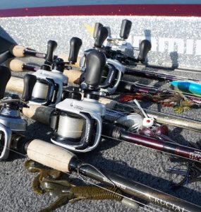 Baitcasting Rod & Reels laid out on the deck of a bass boat.